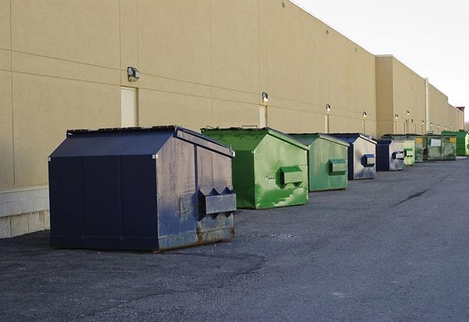 a construction worker moves construction materials near a dumpster in Bremo Bluff VA